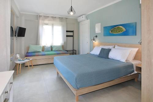 a bedroom with a bed and a couch in it at Sandra's luxury stay in Akti Salonikiou