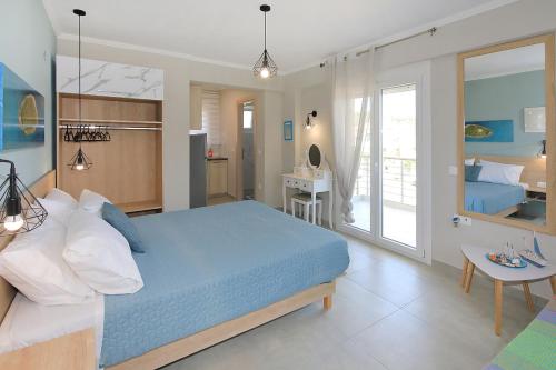 a bedroom with a blue bed and a bathroom at Sandra's luxury stay in Akti Salonikiou