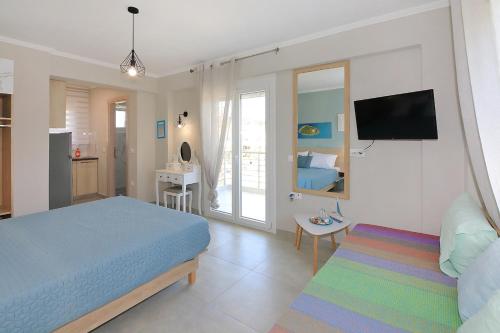 a bedroom with a bed and a room with a tv at Sandra's luxury stay in Akti Salonikiou
