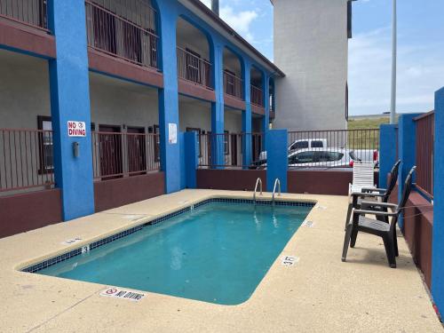 a swimming pool in front of a building at Airport inn & suites in Corpus Christi