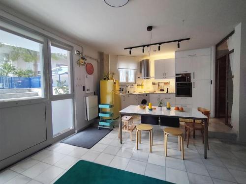 a kitchen with a table and some chairs in it at Υ27 Modern Design Studio in Mytilini
