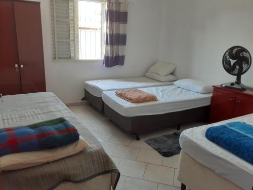 A bed or beds in a room at Casa Agradável próxima ao Bosque