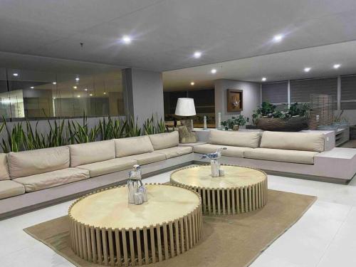 a large living room with couches and two tables at Reserva del Mar - Apto con vista al mar in Santa Marta