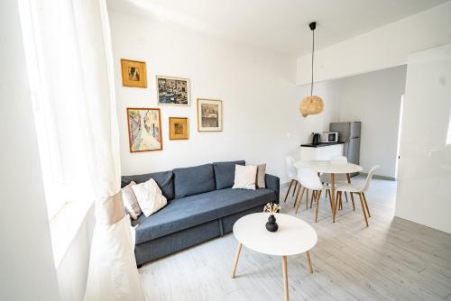 a living room with a blue couch and a table at Valeria Louis perfect getaway - great location Split city center in Split