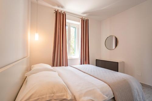 a white bed in a bedroom with a window at Valeria Louis perfect getaway - great location Split city center in Split