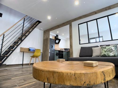 a living room with a table and a couch at Eco-Appart'hôtel Rouen / SLT in Rouen