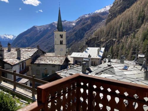 a view from a balcony of a town with a church at appartamento valtournenche il nido in Valtournenche