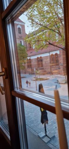 a window with a view of a school courtyard at Old Town apartments with charming terrace in Kaunas