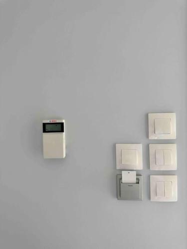 an electrical outlet on a white wall at Zouf house in Panayía Mesosporítissa