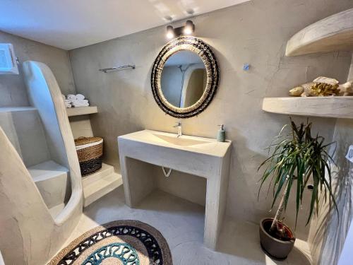 a bathroom with a sink and a mirror at Family Villages Santorini in Vlychada Beach
