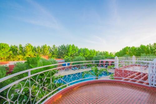 a balcony with a metal railing and a bridge at La Palmeraie De Moulay Yacoub in Moulay Yacoub