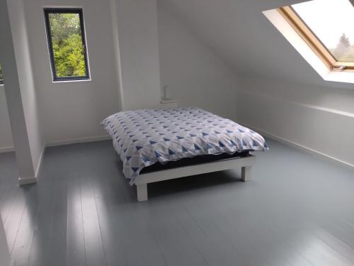 a bed in a white room with a window at Cornacarta Holiday House in Boyle