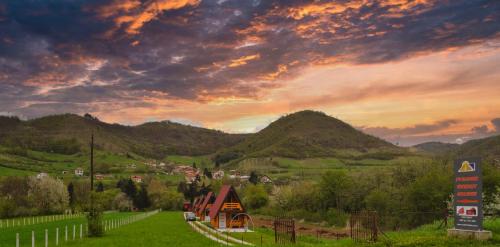 a village in the mountains with a sunset at Pyramid Energy House in Visoko