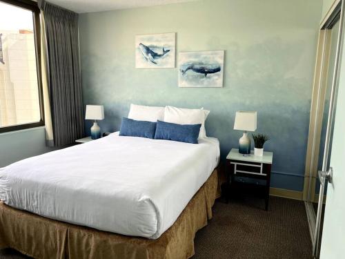 a bedroom with a large bed with blue walls at The Whale Suite @Waikiki Banyan (1 Free Parking) in Honolulu