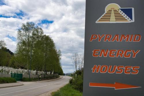 a sign for a pyramid energy house on a road at Pyramid Energy House in Visoko