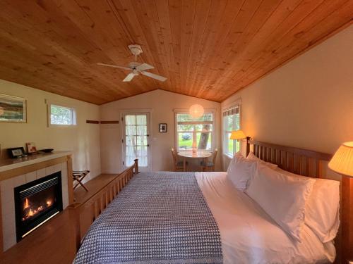 a bedroom with a bed and a fireplace at Lopez Farm Cottages & Tent Camping in Lopez