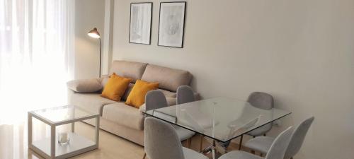 sala de estar con sofá y mesa de cristal en Accommodation Campanario de la Magdalena en Córdoba