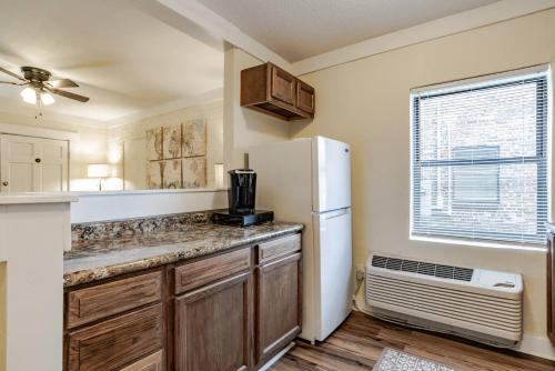 a kitchen with a white refrigerator and a window at The Flats on Florida St - Super Comfy 2-Bedroom Apartments in Mobile