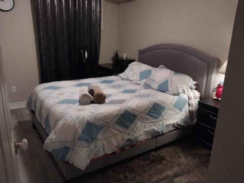 a bedroom with a bed with two stuffed animals on it at Lovely and calm townhouse with free parking in London