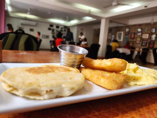 a plate with breakfast food on a table at Altamont West Hotel in Montego Bay