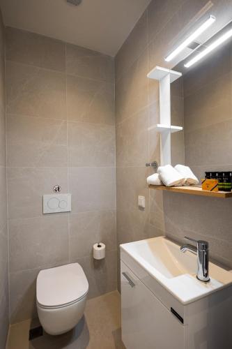 a bathroom with a white toilet and a sink at Stablo Residence in Kanálion