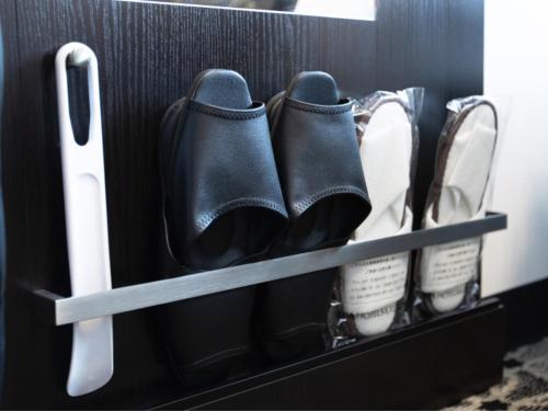 a pair of black shoes in a drawer at APA Hotel Niigata in Niigata