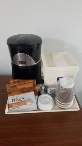 a counter top with a coffee maker and other items at Hotel 2 Queen Beds Hotel Room 208 Wi-Fi Room Booking in Stillwater