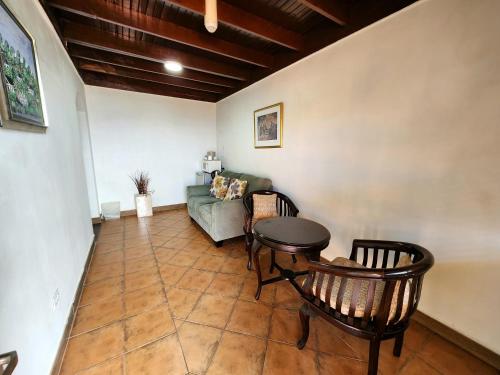 a living room with a couch and a table at Altamont West Hotel in Montego Bay