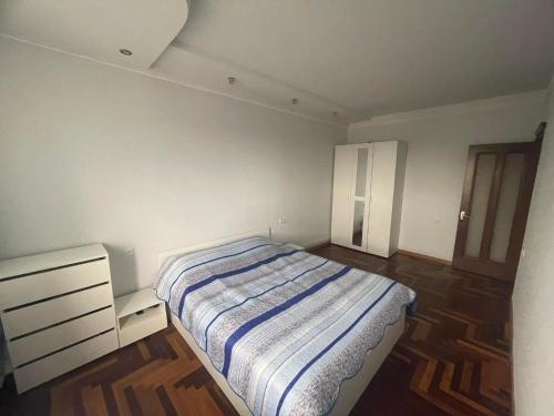 a small bedroom with a bed and a dresser at Apartment to rent in Yerevan in Yerevan