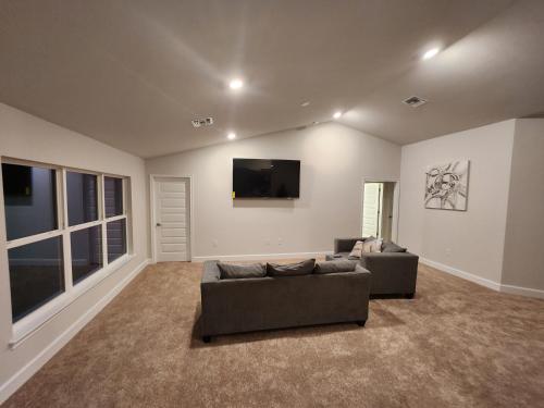 a living room with two couches and a flat screen tv at Home away from home in Port Charlotte