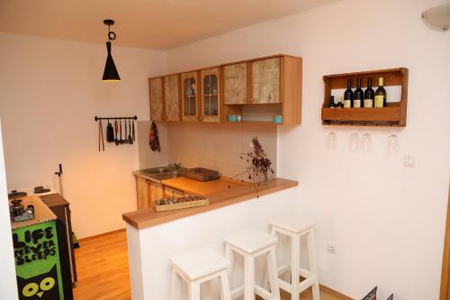 a kitchen with a counter and stools in a room at LAKE HOUSE 'VILIN KONAK' in Nikšić