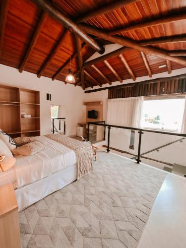 Una cama o camas en una habitación de Abricó Beach Hotel