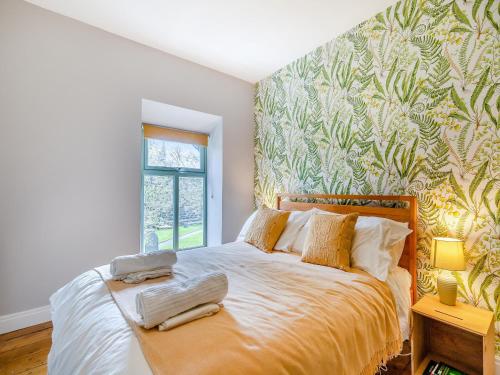 Schlafzimmer mit einem Bett mit einer grünen und weißen Tapete in der Unterkunft Top House in Tideswell
