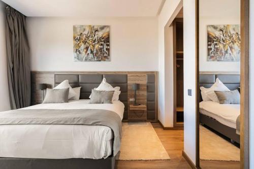 a bedroom with two beds and a mirror at Sublime Appart sur la Corniche , Luxueux et Vue sur Mer in Casablanca