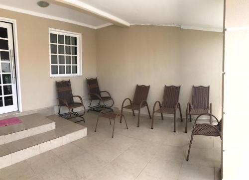 a group of chairs sitting in a room at Propriedade sinta-se em casa in Piranhas
