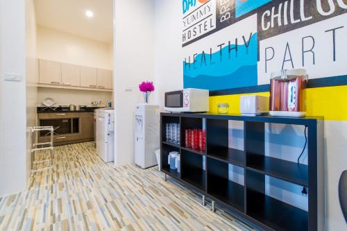 a kitchen with a counter and a refrigerator at Matchbox Bangkok Hostel in Bangkok