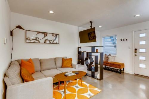 a living room with a white couch and a table at Modern Designer Condo Close to Downtown Austin! in Austin