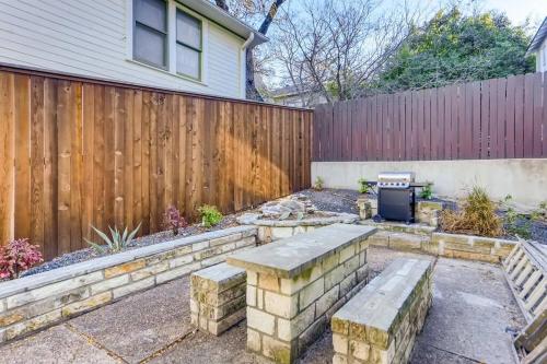 a backyard with a stone bench and a fence at Modern Designer Condo Close to Downtown Austin! in Austin