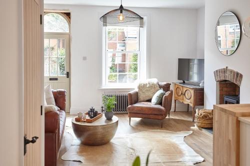 a living room with two chairs and a table at Boutique Fisherman’s Cottage in Cullercoats