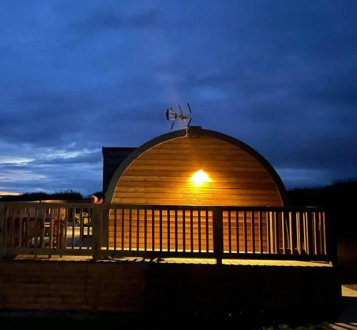 a wooden building with a light on top of it at Caithness View Luxury Farm Lodges and BBQ Huts in Wick