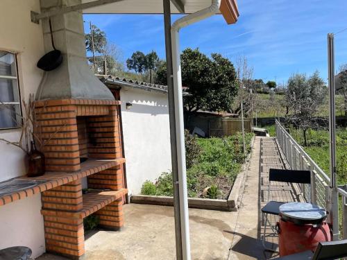 a patio with a brick oven on the side of a house at Casa da Celeste in Vale do Pereiro