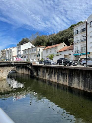 a bridge over a river with cars on it at Casa da Celeste in Vale do Pereiro