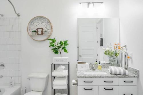 a white bathroom with a sink and a mirror at Cozy Atlanta Apartment in Atlanta