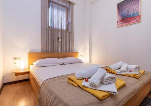 a bedroom with a bed with towels on it at Apartments with a parking space Selce, Crikvenica - 5477 in Selce
