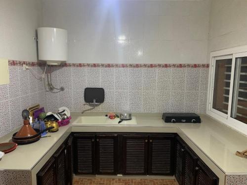 a kitchen with a sink and a counter top at Torre del mar in Moulay Bousselham
