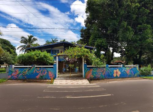 a blue building with graffiti on it next to a street at Pousada Boto in Salvaterra
