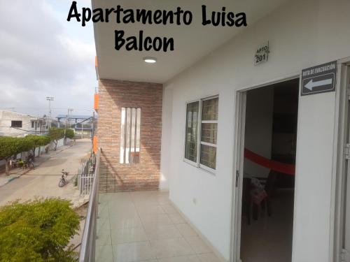 a sign on the side of a building at Apartamentos LUISA in Coveñas