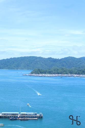 a view of a large body of water with a pier at Homesuite' Home at Jesselton Quay in Kota Kinabalu