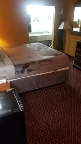 a bed sitting on the floor in a hotel room at OSU 2 Queen Beds Hotel Room 209 Wi-Fi in Stillwater