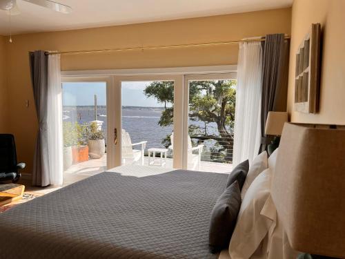 a bedroom with a bed and a view of the ocean at Waterway in Charleston